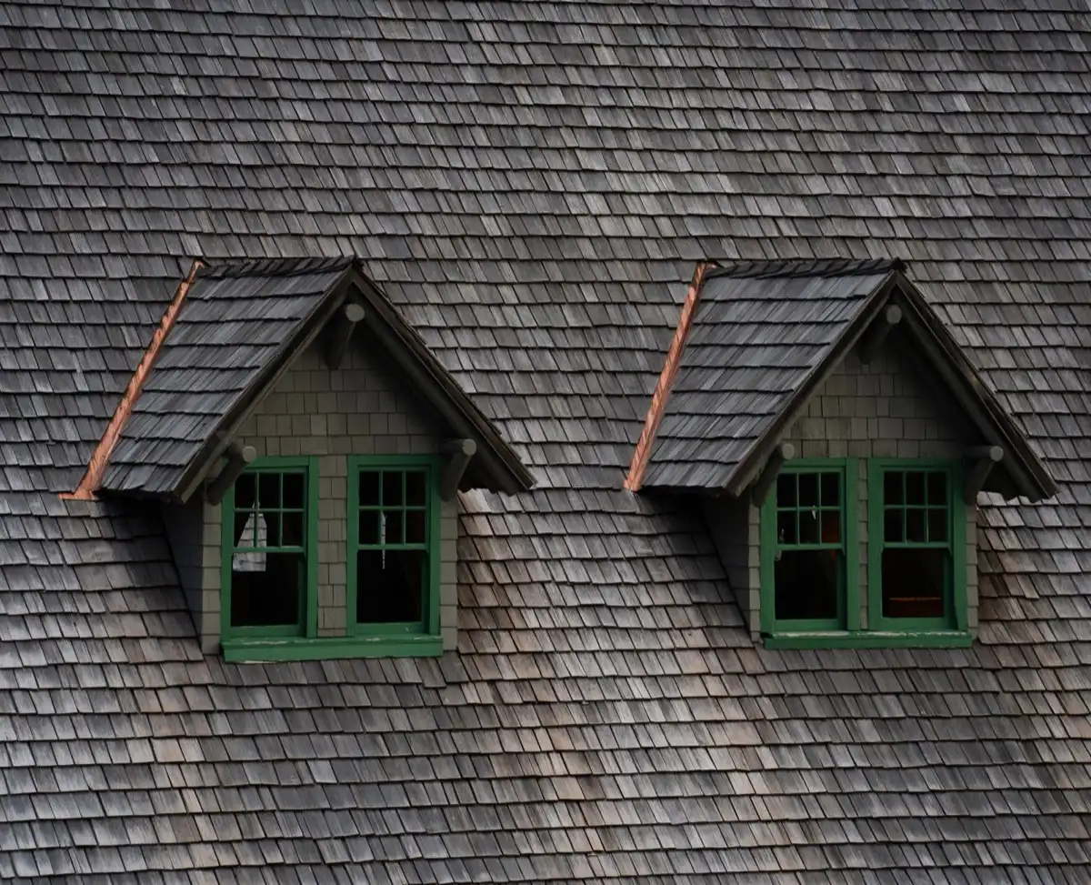Dormers on a shingle roof in Bellingham, WA, where step flashing and kickout flashing carry water past the walls